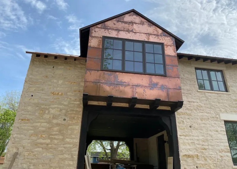 Copper metal panel facade on a stone building for Skylight Installation in Naples Manor