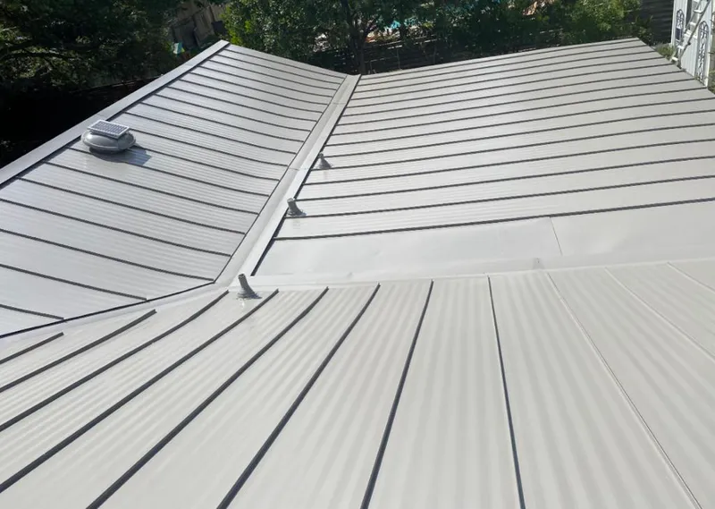 Solar attic fan installed on a metal roof for Roof Ventilation in Naples Manor